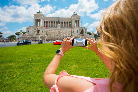 Tourist woman taking photo in Roma, Italy