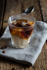Coffee with cream in a glass cup
