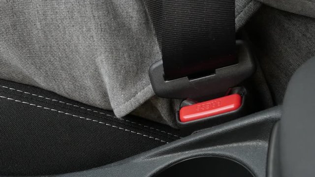 Connecting of three-point seat belt in car slow-mo footage