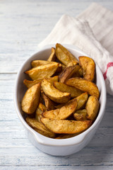 Baked potatoes on a light blue background, selective focus. Delicious vegan homemade food