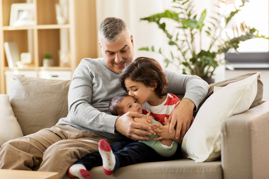 family, fatherhood and people concept - happy father with preteen and baby son at home