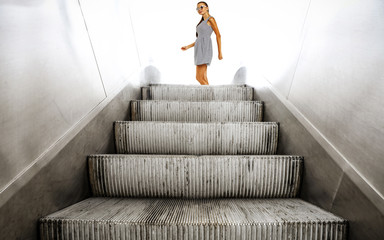 Slim young woman on stairs and free space for your decoration. 