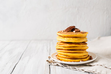 Stack of pancakes with pecan and syrup in nordic style - obrazy, fototapety, plakaty