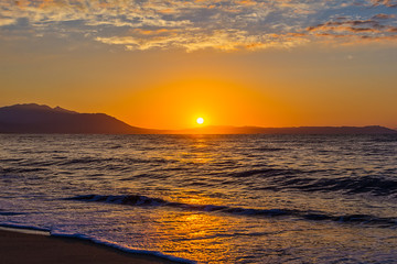 Naklejka premium Early morning , dramatic sunrise over sea and mountain. Photographed in Asprovalta, Greece.