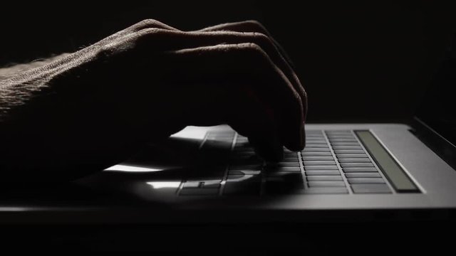 Man Hands Typing On Keyboard Of Modern Laptop On Wooden Table.