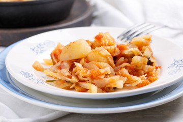 Cabbage stewed with potatoes. Vegetable ragout. Vegan and vegetarian cuisine.