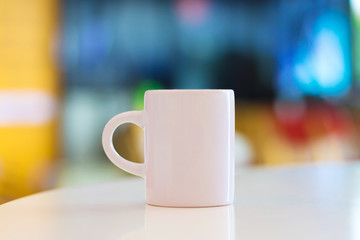 Blank mug on white table background and copyspace. Handle cup or ceramic for your design. Can put your text, image or logo.