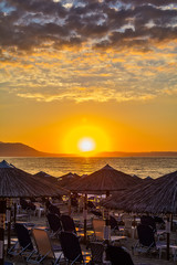 Fototapeta premium View of the sunrise through a local restaurant