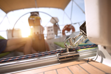 Sailor relaxing in his sailboat at sunset