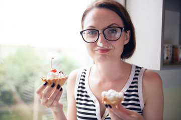 girl eating tasty cakes, sitting by the window, sweet food and pleasure