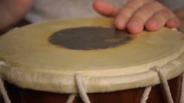 Close up of hands of a man playing a drum. Slow Motion.