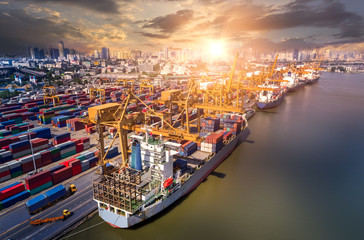 Fototapeta premium Logistics and transportation of Container Cargo ship and Cargo plane with working crane bridge in shipyard at sunrise, logistic import export and transport industry background