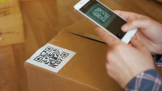 Scanning QR code with smart phone. The man reads the bar code using the application on the smartphone.