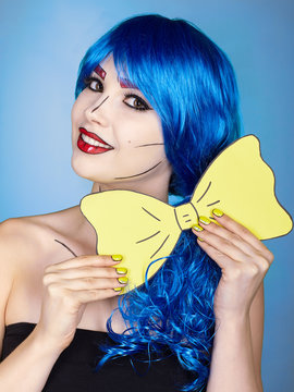 Portrait of young woman in comic  pop art make-up style. Girl with yellow bow-tie in hands