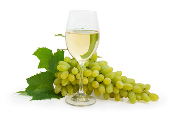 Glass of white wine against of white grapes cluster