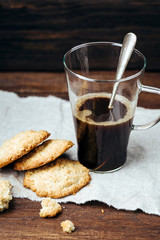 Fototapeta na wymiar Black coffee and homemade cookies, on a wooden background, hot drink, transparent mug