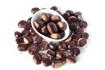 pile of chestnuts in a white bowl isolated