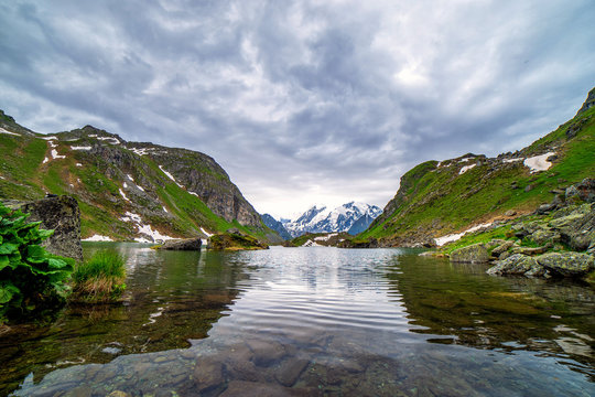 Swiss alps water reflection in Lac de Louvie - mountain lake above Val de Bagnes valley, Switzerland.