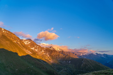 Obraz premium Scenic view of beautiful landscape of Swiss Alps in a Val De Bagnes area. Clouds covering high peaks of Valais Alps (Pennine Alps), Switzerland.