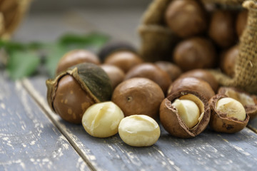 Organic Macadamia nut on wooden table - vintage filter.