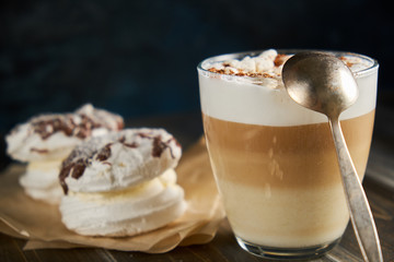 Cup of cappuccino coffee marshmallows on wooden table