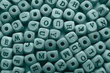 cubes beads letters alphabet / background of wooden cubes with alphabet letters, concept education reading, learning letters