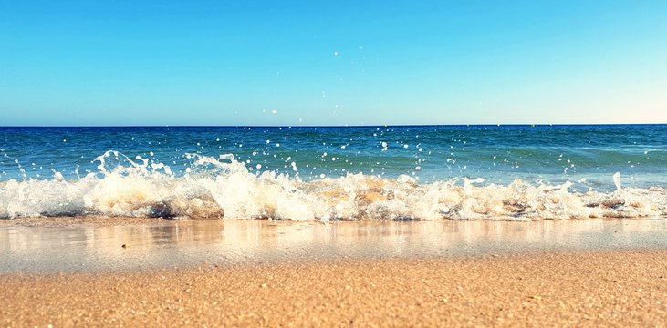 Waves crashing down on the beach in Porto de Mós, Lagos, Portugal 