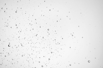white isolated background water drops on the glass / wet window glass with splashes and drops of water and lime, texture autumn background