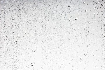 white isolated background water drops on the glass / wet window glass with splashes and drops of water and lime, texture autumn background