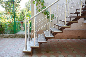 Home metal staircase outdoors. Building new metal steps in house entrance door.
