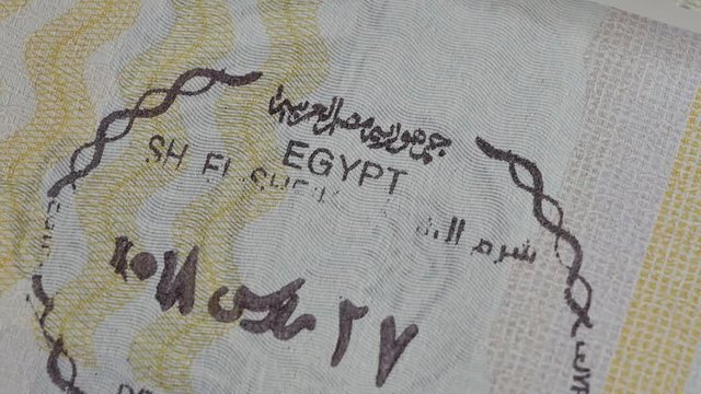 Egypt passport stamp. Entry stamps in passport page. International passports with visas. Elevated view of Egypt entry visa fee