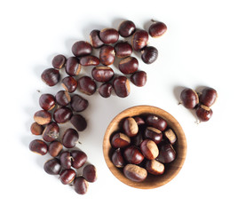 pile of chestnuts in a wooden bowl isolated
