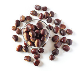pile of chestnuts in a transparent glass bowl isolated
