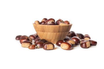 pile of chestnuts in a wooden bowl isolated
