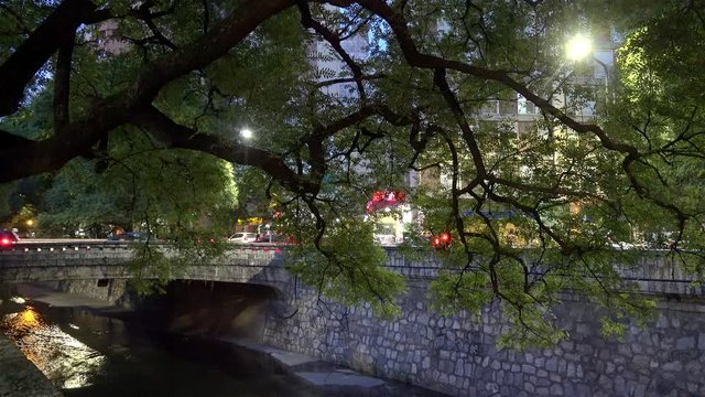 La Canada channel (embanked stream) at the evening twilight. Cordoba, Argentina