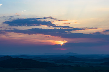 Landscape with the sunset. Orange enlightened cloud clouds and dark landscape.
