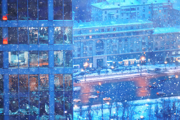snow in a night city skyscrapers / seasonal landscape winter city, snowfall against a background of skyscrapers