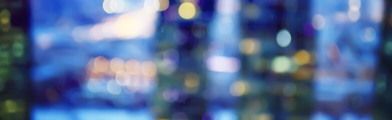blurred bokeh city background / glare and glowing light in night city, modern beautiful bright...