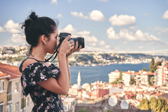 Woman photographer, taking pictures of landscape in old district in Istanbul