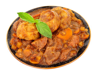 Warming Winter beef and vegetable stew with dumplings isolated on a white background