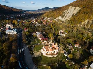 Aerial autumn top view of the Carpathian village at sunny day