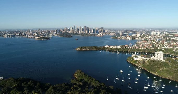 Cremorne point and sandstone head on Sydney Harbour in view of distant city CBD landmark from over Mosman and Taronga zoo.
