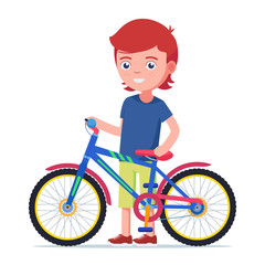 Fototapeta premium Boy standing next to a colorful children bicycle