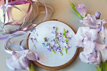 The embroidery process with satin ribbons of light-violet gladiolus flowers (These pictures of embroidery and embroidery with satin ribbons were performed by the author of the images)
