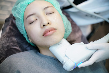 Laser or frequency Skin Tightening Face Lift treatment procedure involves.Young woman receiving...