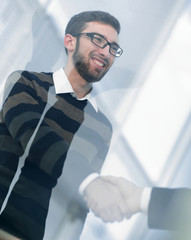 from behind the glass.handshake business people