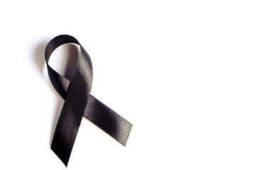 Black ribbon - sign of POW/MIA remembrance and mourning, melanoma awareness, sleep disorders and gang prevention symbol. Isolated on white background, copy space, close up, top view, flat lay. - obrazy, fototapety, plakaty