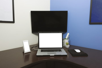 Desk Laptop and mobile with blank text space screen in office on wood table. Laptop mock-up conceptual workspace image.