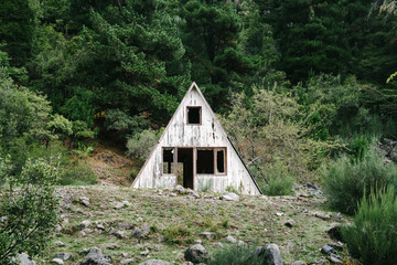 An old and decaying A-Frame cabin in the rural Andes of Chile