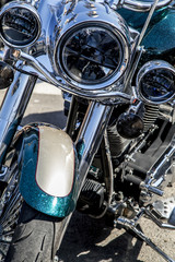 Fototapeta na wymiar Chromed motorcycle engine parts with exhaust pipes,stylish classic chrome-plated motorcycle headlight,close-up,